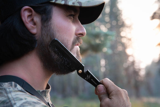 man combing through his his beard that he just washed